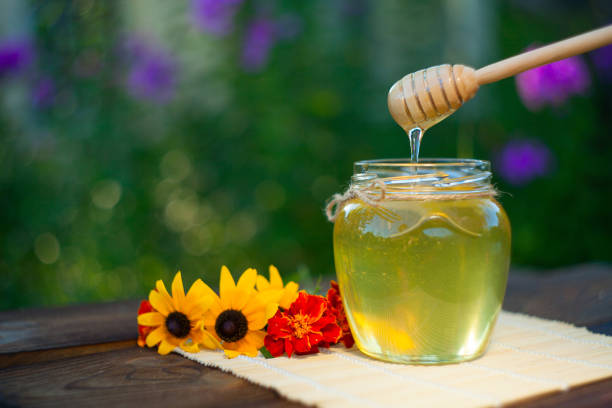 istock Delicious delicious honey in  jar on table 899004226