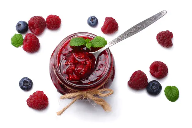 raspberry jam with raspberry berries isolated on white background. top view