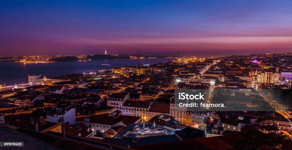 Downtown, Lisbon, Portugal Breathtaking establishing shot of Lisbon, Portugal at dusk overseeing the entire downtown, the Tagus river, the Cristo Rei and the Ponte 25 de Abril suspension bridge. Web Summit Stock Photo
