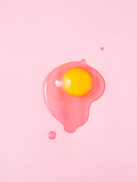 istock Broken egg on pink background. Shot from above 899011860