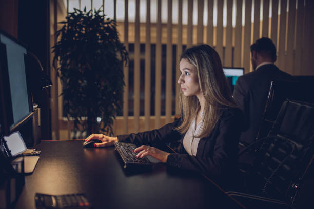 istock Girl working late in office 899012146
