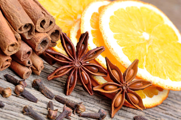 istock Cinnamon with orange fruit anise and cloves on table 899019918