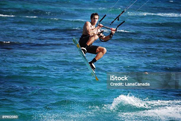 Kitesufer Jumps In The Air Stock Photo - Download Image Now - Barbados, Kiteboarding, Surfing