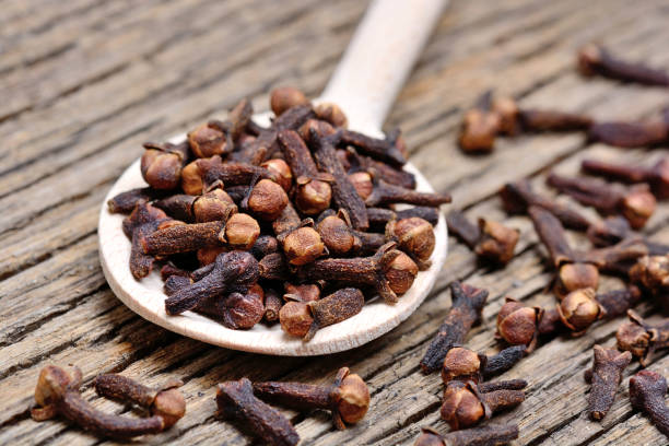 istock Wooden spoon with cloves on table 899024252