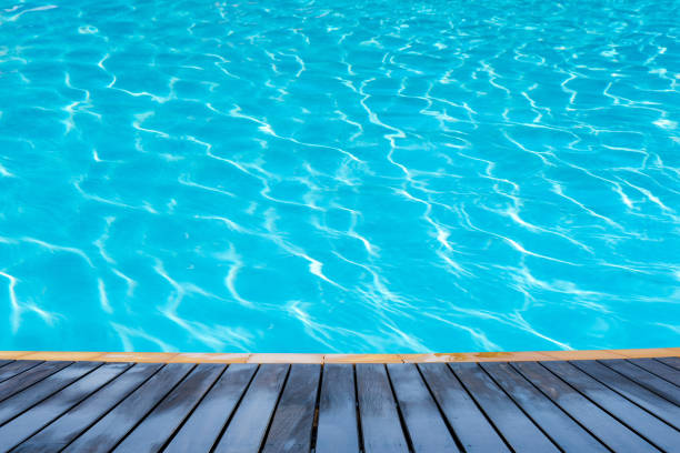 istock wood plate on pool water 899027072