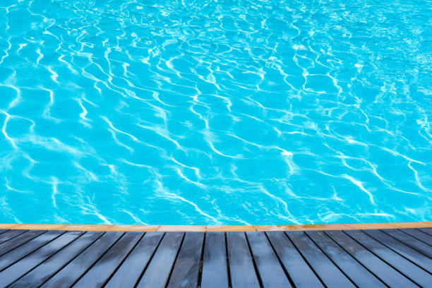 istock wood plate on pool water 899027096