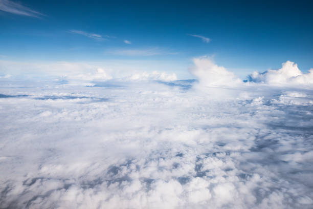 istock cloud and blue sky view from window of airplane 899027438