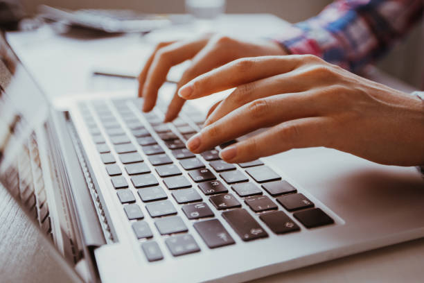istock Cropped View of Hands Typing on Laptop 899028132
