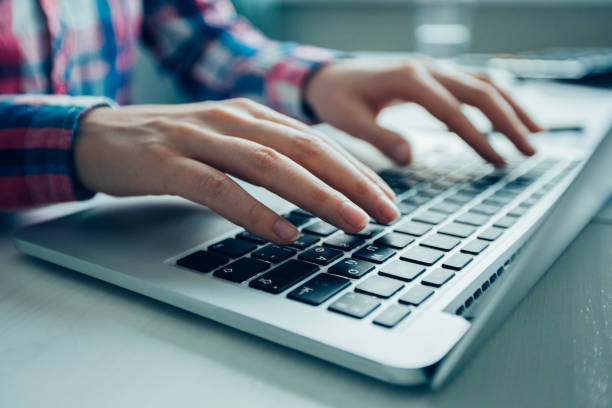 istock Cropped View of Manager Typing on Laptop 899028134
