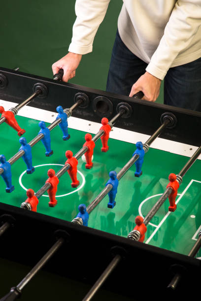 istock Man playing football table game 899031528