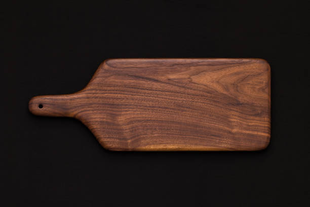 istock Walnut handmade wooden cutting board on black cotton 899031666