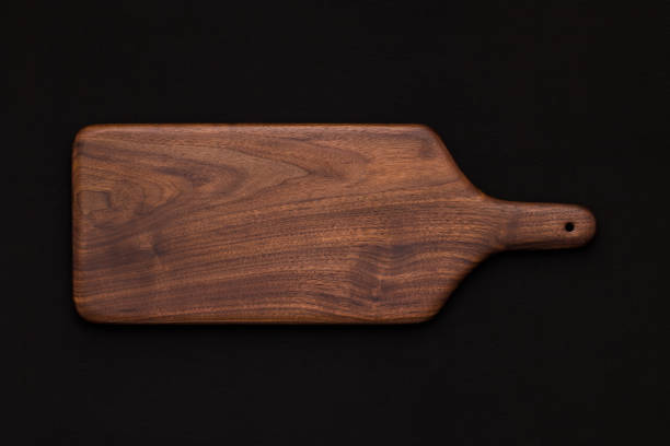 istock Walnut handmade wooden cutting board on black cotton 899031812