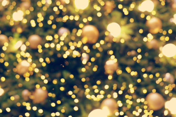 istock Gold Christmas background of de-focused lights with decorated tree 899032870