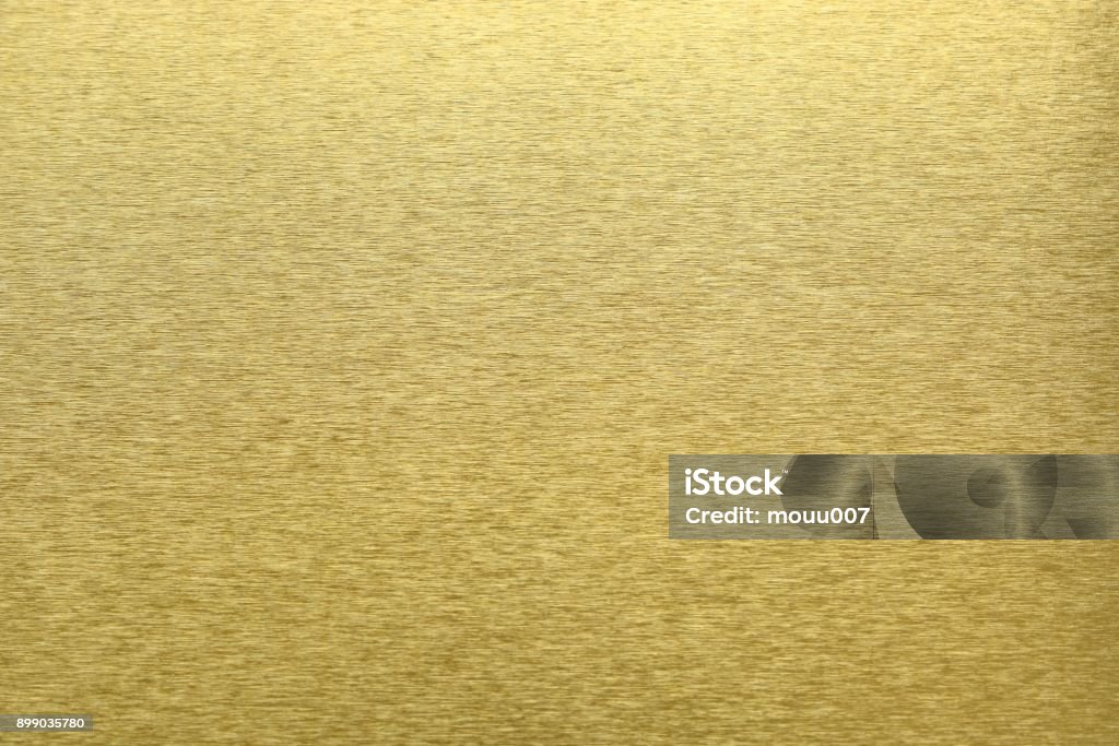 Texture of golden metal, abstract pattern background, selective focus Brushing Stock Photo