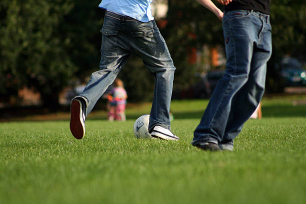 istock Playing football in the park 89904129
