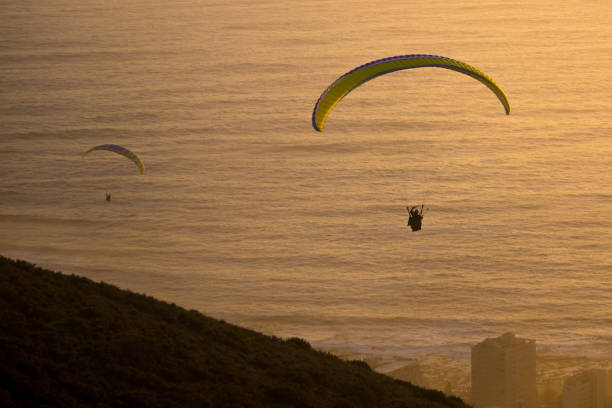istock paragliding in the sunset 899043916