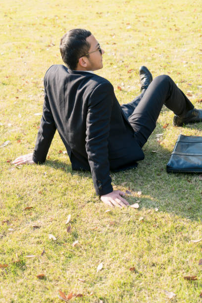istock businessman relax on lawn 899044034
