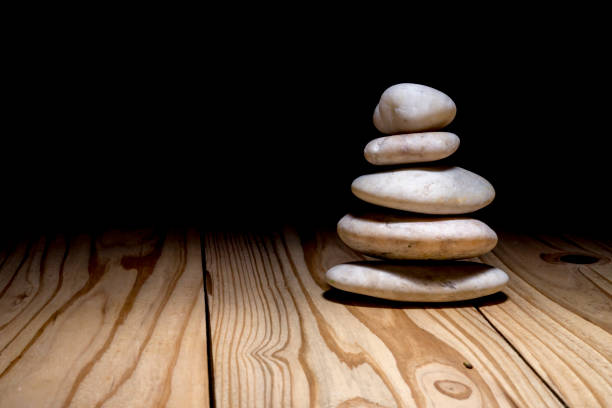 istock Stack of zen stones on wooden background 899047308