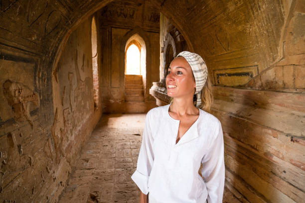 istock Girl contemplating inside ancient temple, Bagan, Myanmar 899047570