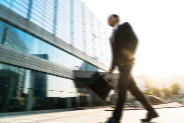 istock young businessman holding briefcase walking in city 899047914