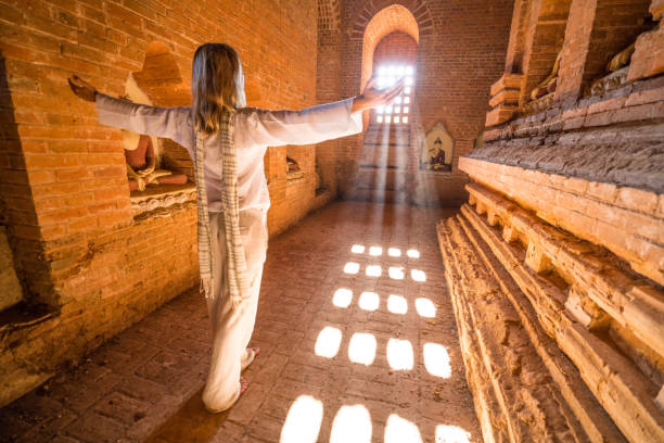 istock Happy woman enjoys visiting ancient temple, Myanmar 899051210