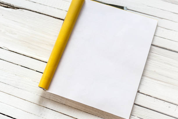 istock Magazine page mock up catalog opened on a white wooden background. Template 899054962
