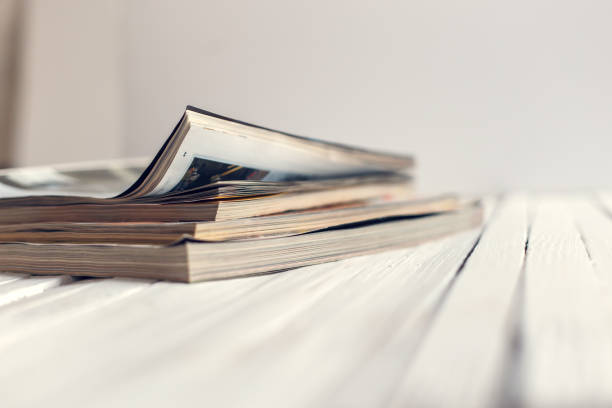 istock Magazine a pack on a wooden white table. Copy space. Vintage filter 899055170