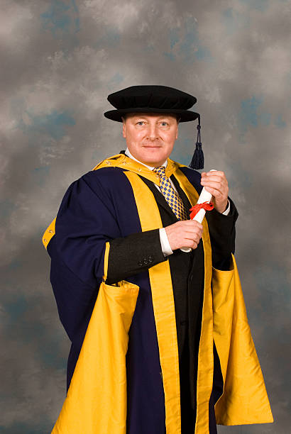 PHD student at graduation ceremony in full robes stock photo