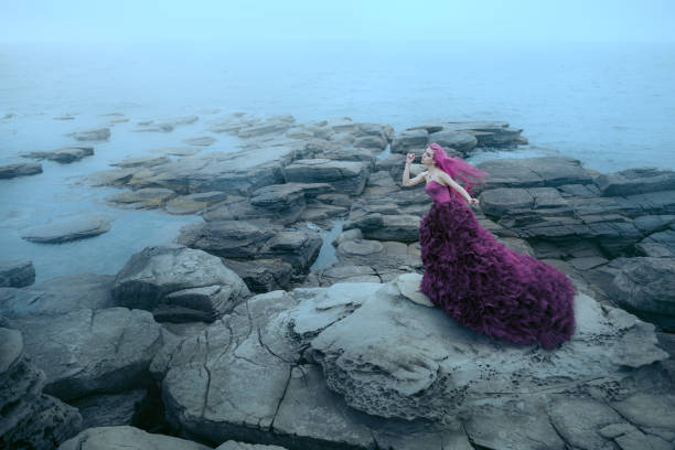woman near foggy sea - beach stone wall one person imagens e fotografias de stock