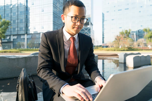 istock young businessman using laptop in city 899059984