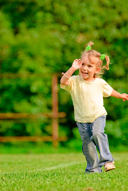 istock Little girl runs across field 89906180