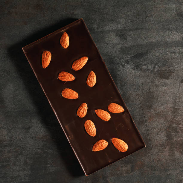 istock The dark chocolate with almonds on a textured steel background 899066188