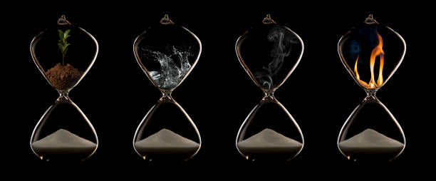 Four elements of fire, plant, water and air in a hourglasses stock photo
