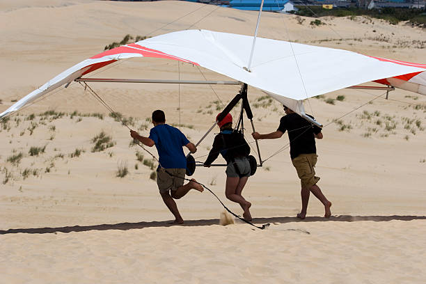 People preparing to take off for hang gliding