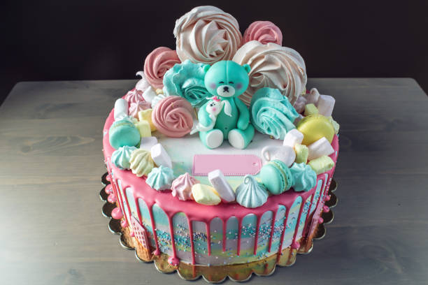 Kids cake decorated with Teddy bear and colorful meringues, marshmallows. Concept of desserts for the birthday children stock photo