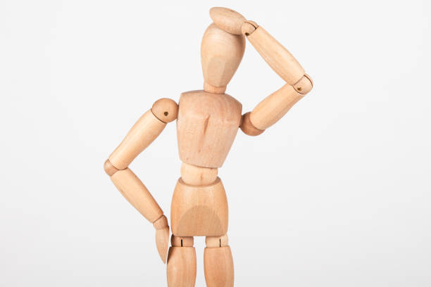 Plain wood mannequin stand upright isolated on white background holding head