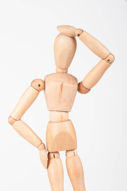 istock Plain wood mannequin stand upright isolated on white background holding head 899083152