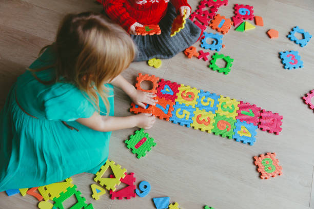 istock kids playing with puzzle, learning numbers and shapes 899087080