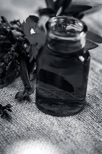 istock Red colored aromatic flowers with its perfume in a glass bottle. 899087546