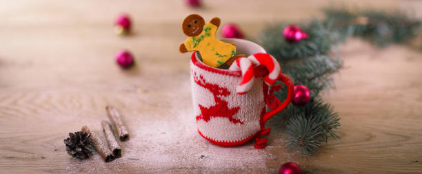 istock Christmas Cup ornament and candy on a wooden table 899090046