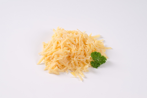 pile of grated raw potatoes on white background