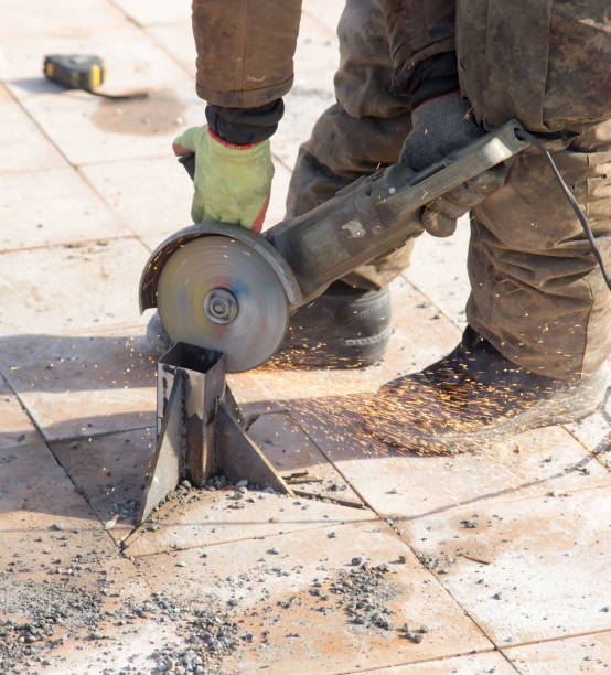 istock Worker cuts metal in the park 899094370
