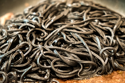 black pasta squid ink closeup italian taglierini al nero di seppia