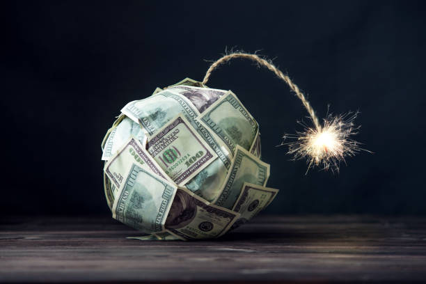 Bomb of money hundred dollar bills with a burning wick. Little time before the explosion. Concept of financial crisis stock photo