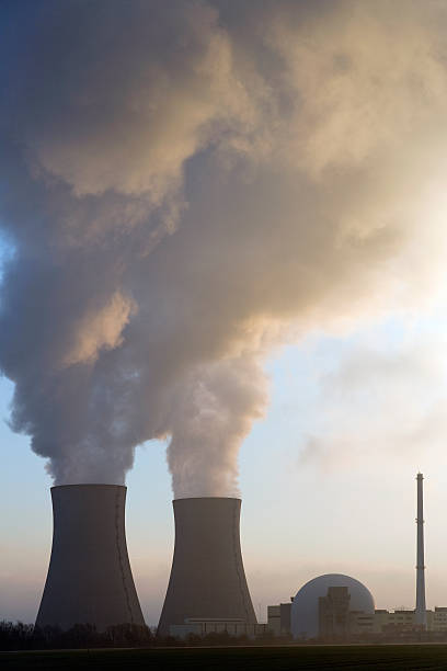 istock Nuclear power station with steaming cooling towers at sunrise (XL) 89910241