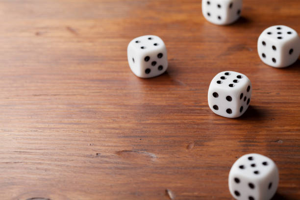 istock Game of chance concept. White dice on rustic wooden board. 899103906