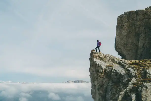 Young Caucasian man  standing on Seceda mountain in Dolomites