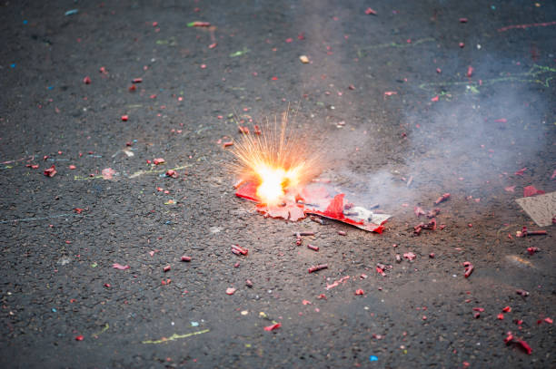 Firecracker exploding in the street stock photo
