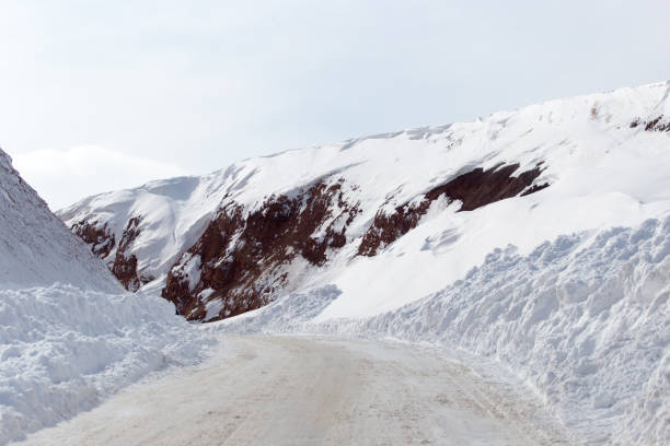 istock snowy road in the mountains 899111520