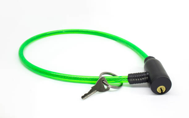 istock Green bike cable lock with key isolated on white background 899113730
